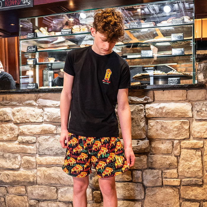 Youth model wearing black youth graphic tee with “Pizza Guy” design