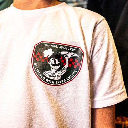 Youth model wearing white youth graphic tee with “Pizza Shop” design