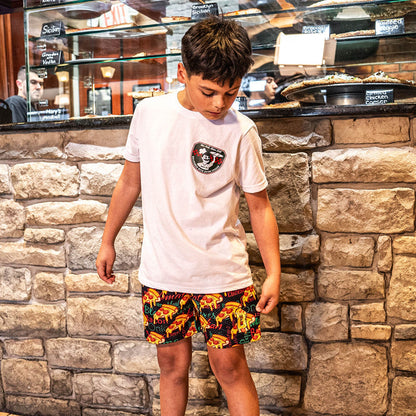 Youth model wearing white youth graphic tee with “Pizza Shop” design
