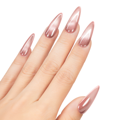 Hand with long, pointed nails painted with a pink nail polish on a white background
