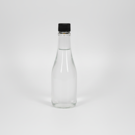 Clear glass bottle with a black cap on a white background