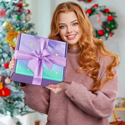 woman holding a purple gift box with a lavender ribbon in front of a decorated christmas tree