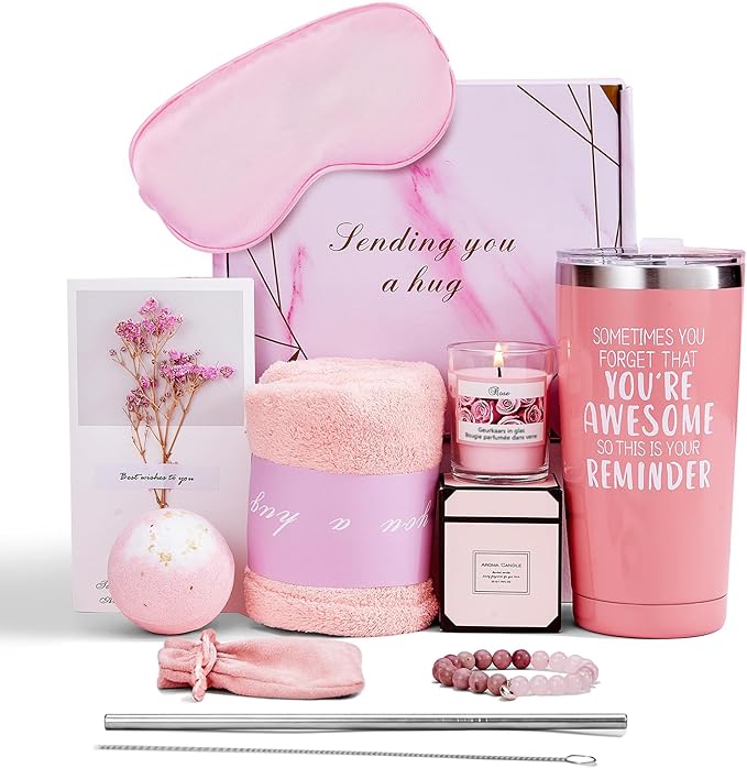 Pink self-care gift set including a tumbler, silk eye mask, candle, bath bomb, towel, bracelet, gift card, straw, and pink “Sending you a hug” box.
