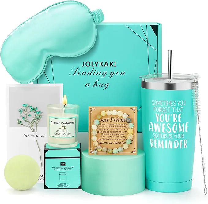 A turquoise women’s spa gift set including an insulated tumbler, silk eye mask, scented candle, bath bomb, greeting card, and gemstone bracelet, arranged in front of a matching gift box labeled ‘JOLYKAKI – Sending you a hug.