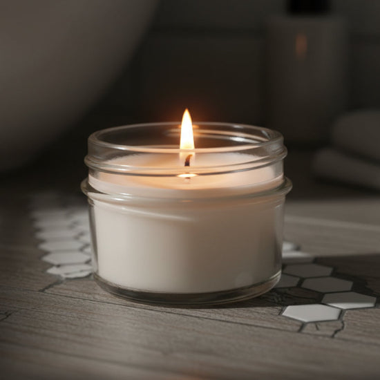Clear glass jar candle  on a counter