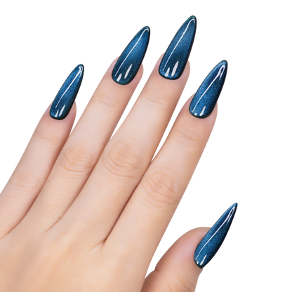 Hand with blue glittery nail polish on a white background