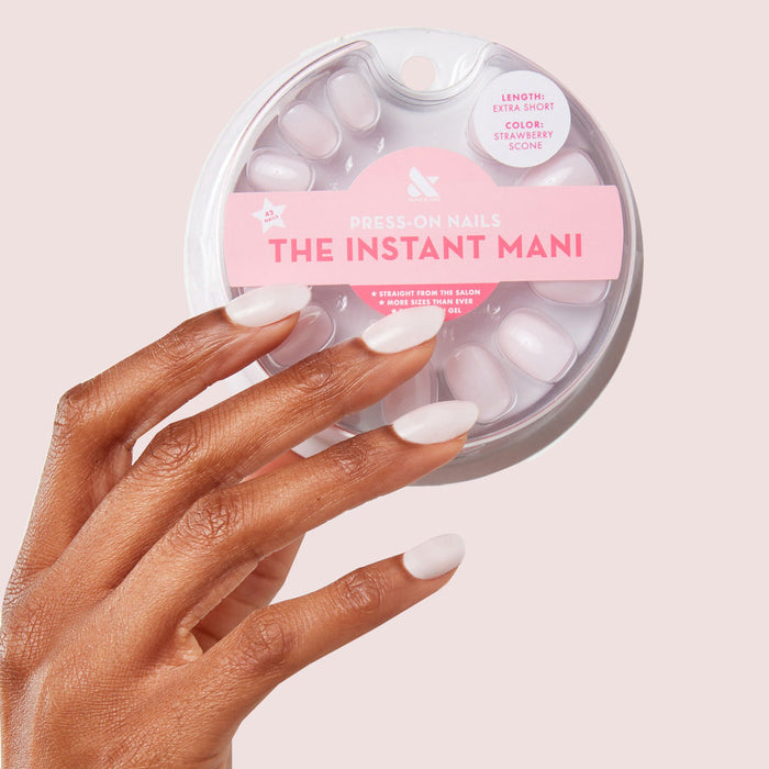 Hand with Strawberry Scone - Press-On | XS | Round showcasing extra-short, sheer pink press-on nails manicure