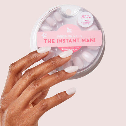 Hand with Strawberry Scone - Press-On | XS | Round showcasing extra-short, sheer pink press-on nails manicure