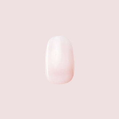 Single nail featuring Strawberry Scone - Press-On | XS | Round with extra-short, semi-sheer pink press-on manicure design