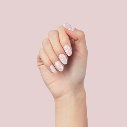 Super Stars - Press-On | Short | Round hand with short round false nails featuring white stars on a pale pink base