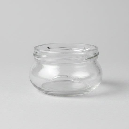 Clear glass jar on a grey background