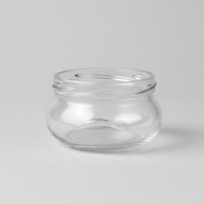 Clear glass jar on a grey background
