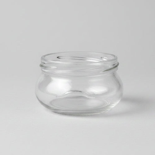 Clear glass jar on a grey background