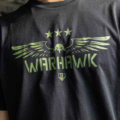 Close up of Youth black t-shirt featuring an army green eagle graphic with green “WARHAWK” lettering and a green Armor BL101 logo