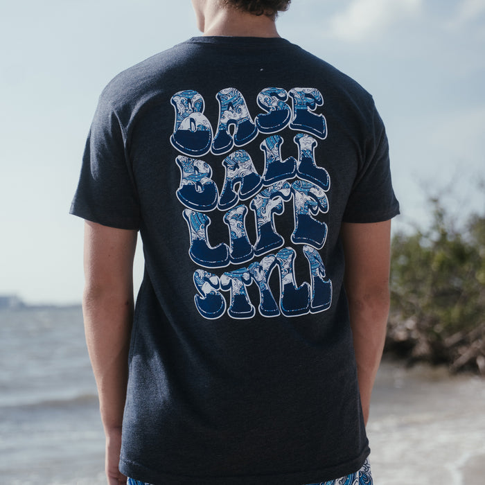 Youth model wearing navy Wave youth graphic tee