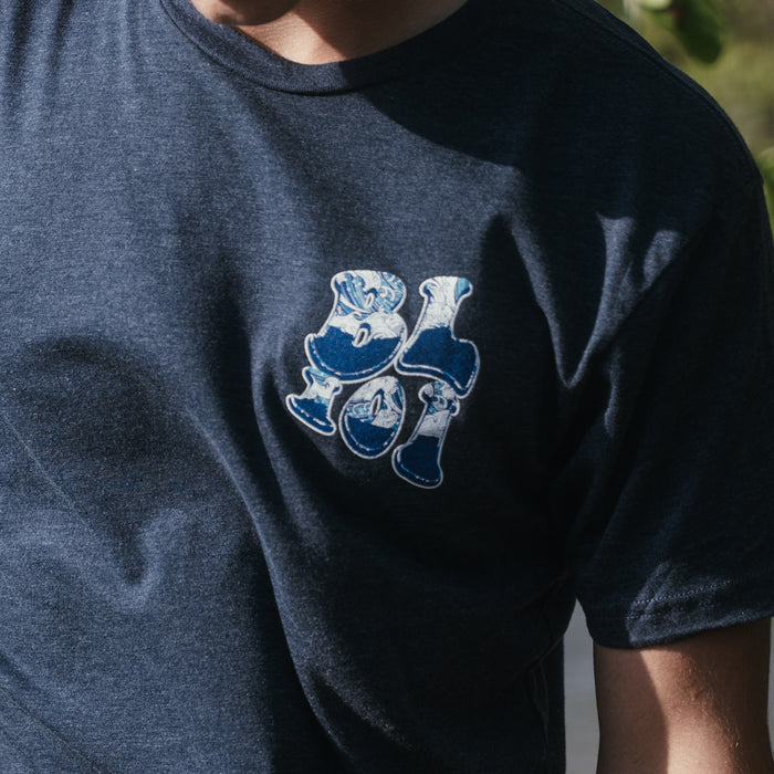 Youth model wearing navy Wave youth graphic tee