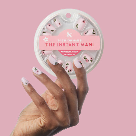 Wild Bouquet - Press-On | Short | Squoval with soft pink base and detailed wildflower designs on hand holding circular packaging