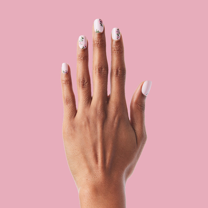 Wild Bouquet - Press-On | Short | Squoval short nails with soft pink base and delicate floral accents on hand against pink background