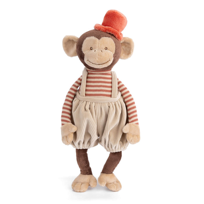 Standing plush monkey with orange cap, striped shirt, cream overalls, and rounded ears