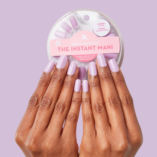 Hands wearing You're Invited - Press-On | Short | Squoval with playful lilac purple short squoval press-on manicure