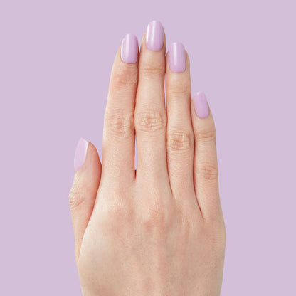 Hand with You're Invited - Press-On | Short | Squoval featuring short squoval false nails in soft lilac polish manicure